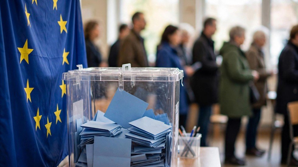 Alegeri europene 2026: urnă de vot și steagul Uniunii Europene într-o secție de votare
